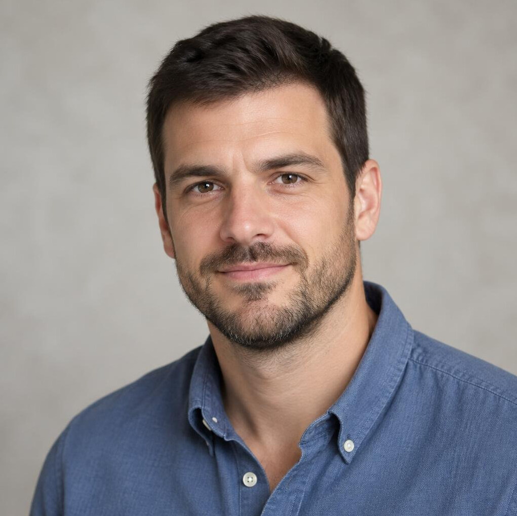 Portrait of a man with a beard smiling outdoors